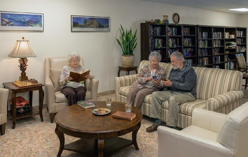 A group of people, including a man and a woman, are sitting on a couch and watching TV. They are holding a bag of popcorn. AI generated content