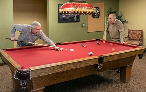 Four people are playing a game of ping pong in a room. AI generated content